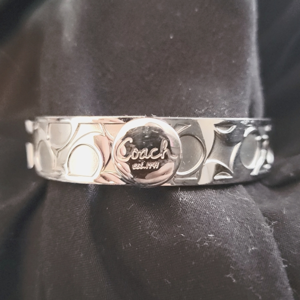 Gently worn Coach Silver bangle bracelet with "C" logo all over.
